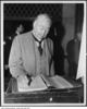 Original title:  Sir Henry Pellatt signs Casa Loma guest book. [ca. 1930] City of Toronto Archives, Fonds 1244, Item 4013, William James family fonds. 