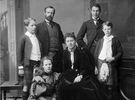 Original title:  Lord and Lady Aberdeen and family. L. to R. – standing: Dudley Gordon, Lord Aberdeen, George Gordon, and Archie Gordon – seated: Marjorie Gordon and Lady Aberdeen. 
NATIONAL LIBRARY AND ARCHIVES; MIKAN 3423567