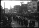 Original title:  Vancouver Public Library. Funeral procession for David C. Lew. Number 6 of a series VPL 17714-17725. Sun Tower visible in the background. Vancouver, B.C.
Date: October 25, 1924. Photographer/Studio: Thomson, Stuart.