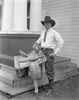 Original title:  Title: Pete Knight, Calgary Exhibition and Stampede champion, with trophy saddle. Date: 1927. Photographer/Illustrator: Oliver, W.J., Calgary, Alberta. Remarks: Winner of the North American bucking horse contest. Image courtesy of Glenbow Museum, Calgary, Alberta.