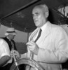 Original title:  The Honourable C.D. Howe at the wheel of a tug during its launch ceremony at the Central Bridge Company. 