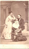 Original title:  Image from Hamilton Public Library, Local History and Archives. Photo of W.E. Sanford and his second wife, Harriet Sophie Vaux (1848-1938). Sanford is holding their first child, Edward Jackson Sanford, born in St Paul Minnesota, in June 1867. 