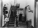 Titre original&nbsp;:  Fig. 12B. Interior View of the Thomas McMurray Residence, Salem. Image courtesy of Yarmouth County Museum and Archives. Mr. McMurray stops halfway down the stairs, while his wife waits outside the doors to the kitchen and dining room. (PH-32-MacMurray-1A, YCMA).