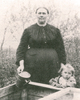 Original title:  Anna Toews (1868-1933) with her daughter Margaret (1908-25) standing behind a cold frame which was used to start plants. Taken around 1912/13 which would have been shortly after they returned from Needles, BC.
Source: Cathy Barkman, “Anna Toews (1868–1933): midwife,” Preservings (Steinbach, Man.), 10 (June 1997), pt.2: 51. [https://www.plettfoundation.org/files/preservings/Preservings10-2.pdf] 
