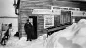 Original title:  Western Canada Airways' first office at Hudson. The man in the doorway is J.A. McDougall, Treasurer of Western Canada Airways. 