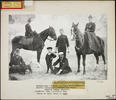 Original title:  Maple Creek, Saskatchewan, 1894. Inspector Zachary Taylor Wood (standing in centre, with son). Seated: Surgeon S.M. Fraser (with dogs), Sheriff Duncan Campbell. Mounted: Mrs. Z.T. Wood (left), Mrs. White-Fraser (right) 