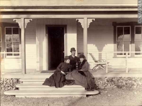 Original title:  Elliott Galt with one of his sisters and a cousin outside 