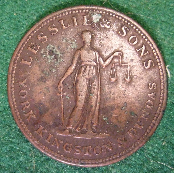 Original title:    Description Lesslie and Sons business token from 19th Century Ontario Canada. Date 7 March 2009, 02:48 Source CANADA, ONTARIO, YORK KINGSTON and DUNDAS 19th C. LESSLIE and SONS HALFPENNY TOKEN b Author Jerry 